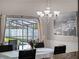 Bright dining room with chandelier overlooking the screened-in patio and pool area, next to an open kitchen at 1101 Maidenmoor Rd, Winter Garden, FL 34787