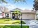Inviting single-story home with a well-manicured lawn, complemented by a two-car garage and covered entry at 1101 Maidenmoor Rd, Winter Garden, FL 34787