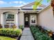 Welcoming entrance with meticulously maintained landscaping, leading to a modern front door with glass accents at 1101 Maidenmoor Rd, Winter Garden, FL 34787