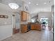 Kitchen with wood cabinets, tile floors, stainless steel dishwasher and granite counters shows view to dining at 1101 Maidenmoor Rd, Winter Garden, FL 34787