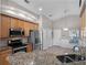 Kitchen area features stainless steel appliances, granite counters, and wood cabinets at 1101 Maidenmoor Rd, Winter Garden, FL 34787