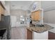 Kitchen area features stainless steel appliances, tile backsplash, granite counters, and oak cabinets at 1101 Maidenmoor Rd, Winter Garden, FL 34787