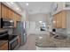 Kitchen features stainless steel appliances, granite counters, oak cabinets, and tile flooring at 1101 Maidenmoor Rd, Winter Garden, FL 34787