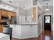 A view of the kitchen features granite countertops, stainless steel appliances, and access to the front door at 1101 Maidenmoor Rd, Winter Garden, FL 34787