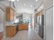 Open kitchen with stainless steel appliances, tile floors, and granite countertops provides sightlines to the dining area at 1101 Maidenmoor Rd, Winter Garden, FL 34787