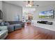 Comfortable living room with hardwood floors open to the dining and kitchen area boasts a wall-mounted TV at 1101 Maidenmoor Rd, Winter Garden, FL 34787