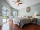 Light-filled main bedroom with wood floors and a sliding glass door provides access to the screened pool at 1101 Maidenmoor Rd, Winter Garden, FL 34787