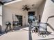 Covered patio with an outdoor dining table and television, perfect for entertaining by the pool at 1101 Maidenmoor Rd, Winter Garden, FL 34787