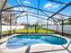 Refreshing screened-in pool with water features, surrounded by a lush backyard and privacy fence at 1101 Maidenmoor Rd, Winter Garden, FL 34787