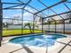 Enclosed in a black frame, a beautiful private pool with a sun-drenched backyard, and a white fence at 1101 Maidenmoor Rd, Winter Garden, FL 34787