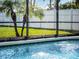 Clear blue pool water with fountain features enclosed by a black frame in a private backyard with a white fence at 1101 Maidenmoor Rd, Winter Garden, FL 34787