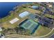Aerial view showcasing community sport courts: tennis, sand volleyball, basketball, and an ice rink at 1101 Maidenmoor Rd, Winter Garden, FL 34787