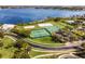 Aerial view of tennis, volleyball, hockey, basketball, and community pool and lake in background at 1101 Maidenmoor Rd, Winter Garden, FL 34787