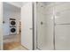 Bathroom with a walk-in shower and view of laundry area at 114 Rum Run, Davenport, FL 33837