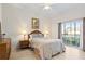 Main bedroom with wicker furniture and private balcony access at 114 Rum Run, Davenport, FL 33837