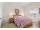 Bright bedroom with a queen bed, nightstands, and large window at 114 Rum Run, Davenport, FL 33837