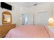 Main bedroom with a queen bed, dresser, and access to other rooms at 114 Rum Run, Davenport, FL 33837
