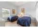 Two twin beds in a well-lit bedroom with window and wood-look flooring at 114 Rum Run, Davenport, FL 33837