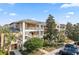 Two-story condo building with inviting landscaping and ample parking at 114 Rum Run, Davenport, FL 33837