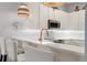 Modern kitchen with white cabinets, breakfast bar, and stylish lighting at 114 Rum Run, Davenport, FL 33837