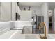 Modern kitchen featuring white cabinets, quartz counters, and gold faucet at 114 Rum Run, Davenport, FL 33837