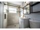 Updated bathroom with a walk-in shower, modern vanity, and tile flooring at 1232 Saint James Rd, Orlando, FL 32808