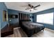 Serene bedroom with dark blue walls, a king-size bed, and ceiling fan at 1232 Saint James Rd, Orlando, FL 32808