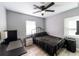 Cozy bedroom with metal bed frame, ample natural light, and ceiling fan at 1232 Saint James Rd, Orlando, FL 32808