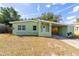 Charming light green house with a carport and well-maintained lawn at 1232 Saint James Rd, Orlando, FL 32808