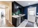 Stylish kitchen featuring dark cabinetry, green tile backsplash, and stainless steel appliances at 1232 Saint James Rd, Orlando, FL 32808