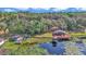 Aerial view of a beautiful lake house, gazebo, dock, and expansive property with lush trees and serene water at 15040 Ne 248Th Avenue Rd, Fort Mc Coy, FL 32134