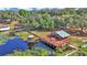 Charming lake house with a large deck, gazebo, and a serene waterfront setting surrounded by lush trees at 15040 Ne 248Th Avenue Rd, Fort Mc Coy, FL 32134
