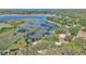 Aerial view of lakeside property with lush greenery and serene lake at 15040 Ne 248Th Avenue Rd, Fort Mc Coy, FL 32134
