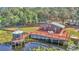 Aerial view of house with a deck and a gazebo located on a lake with lily pads at 15040 Ne 248Th Avenue Rd, Fort Mc Coy, FL 32134
