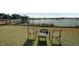 Backyard featuring seating area, fire pit, dock and a lake at 15040 Ne 248Th Avenue Rd, Fort Mc Coy, FL 32134