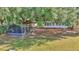 Spacious backyard featuring mature trees and a screened in grilling area at 15040 Ne 248Th Avenue Rd, Fort Mc Coy, FL 32134