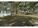 Expansive backyard with mature trees, offering ample space for outdoor activities and enjoying nature at 15040 Ne 248Th Avenue Rd, Fort Mc Coy, FL 32134