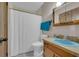 Clean bathroom with a white toilet, shower, and wood vanity at 15040 Ne 248Th Avenue Rd, Fort Mc Coy, FL 32134