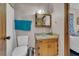 Neutral bathroom with a wood vanity, sink, medicine cabinet and a toilet at 15040 Ne 248Th Avenue Rd, Fort Mc Coy, FL 32134