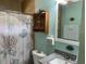 Cozy bathroom with a shower, seashell-themed curtain, and granite vanity, providing a clean and comfortable space at 15040 Ne 248Th Avenue Rd, Fort Mc Coy, FL 32134