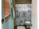 Functional bathroom with a shower, seashell curtain, and a window, offering a pleasant and practical space at 15040 Ne 248Th Avenue Rd, Fort Mc Coy, FL 32134