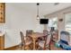Bright dining area with wood table and chairs near kitchen and TV at 15040 Ne 248Th Avenue Rd, Fort Mc Coy, FL 32134