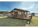 Charming waterfront cottage with a wooden deck, dock, and boat on a picturesque lake at 15040 Ne 248Th Avenue Rd, Fort Mc Coy, FL 32134