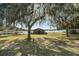 Charming exterior view of this waterfront home with mature trees and waterfront access at 15040 Ne 248Th Avenue Rd, Fort Mc Coy, FL 32134
