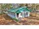 Charming bungalow with covered entry and lovely plants, offering a warm and inviting curb appeal at 15040 Ne 248Th Avenue Rd, Fort Mc Coy, FL 32134