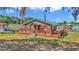Charming waterfront cottage with a wooden deck, dock, and boat on a picturesque lake at 15040 Ne 248Th Avenue Rd, Fort Mc Coy, FL 32134