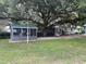 Quaint backyard featuring a charming screened porch and large tree at 15040 Ne 248Th Avenue Rd, Fort Mc Coy, FL 32134
