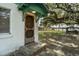 Charming home exterior showing the entry door, with water view, and beautiful mature tree at 15040 Ne 248Th Avenue Rd, Fort Mc Coy, FL 32134