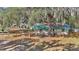 Cozy cottage with fenced yard nestled among lush trees creating a private and inviting home at 15040 Ne 248Th Avenue Rd, Fort Mc Coy, FL 32134