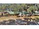 This charming cottage features a fenced yard, lush trees, and a cozy ambiance with a cottage in the background at 15040 Ne 248Th Avenue Rd, Fort Mc Coy, FL 32134